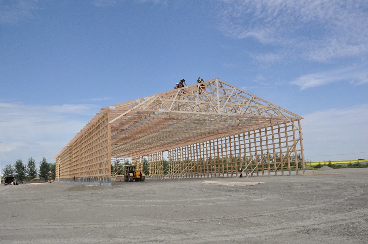 The crew is installing trusses on a new building