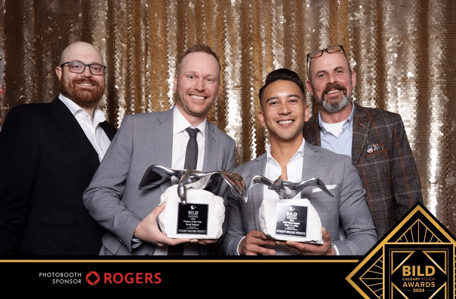 Integrity Building Products team members proudly holding their BILD Awards for Supplier of the Year and Partner of the Year at the 2024 Calgary Region gala.